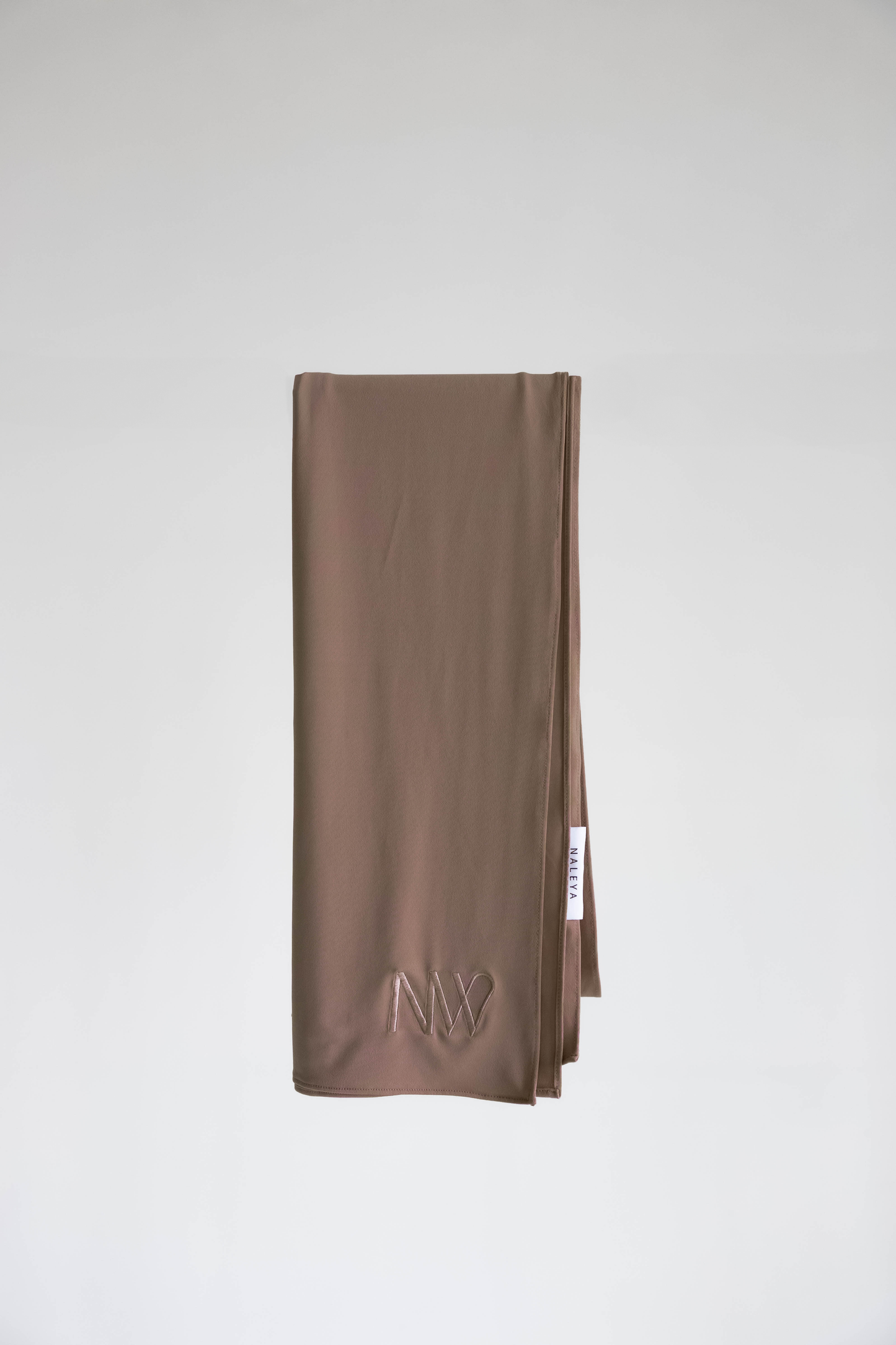 Premium jersey hijab in brown by Naleya Wear, folded and displayed on a neutral background
