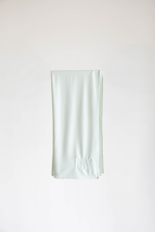 Premium jersey hijab in ice white by Naleya Wear, folded and displayed on a neutral background