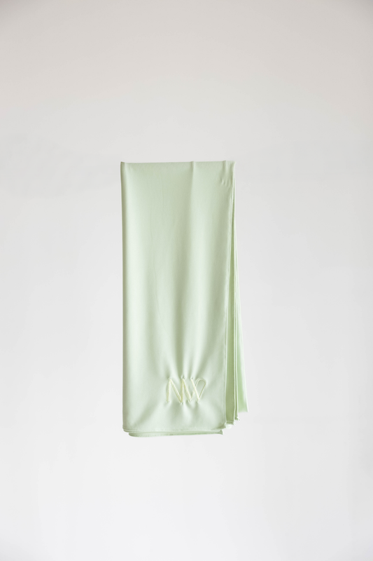 Premium jersey hijab in pastel green by Naleya Wear, folded and displayed on a neutral background