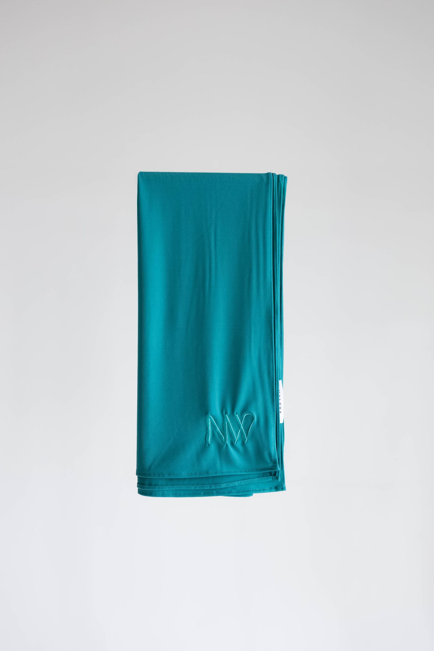 Premium jersey hijab in turqouise by Naleya Wear, folded and displayed on a neutral background