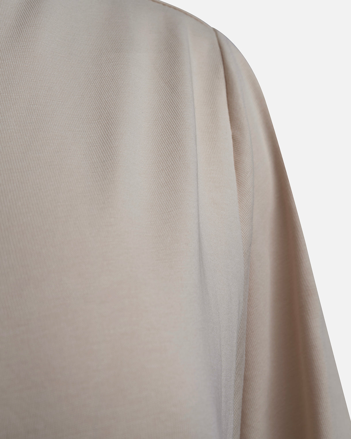 Eco-friendly abaya dress made of Sorona bio-cotton, lightweight and breathable material in color beige, close up cotton material displayed on a neutral background