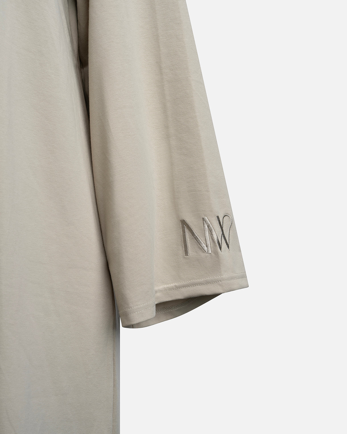 Eco-friendly abaya dress made of Sorona bio-cotton, lightweight and breathable material in color sage green, close up naleya wear logo displayed on a neutral background