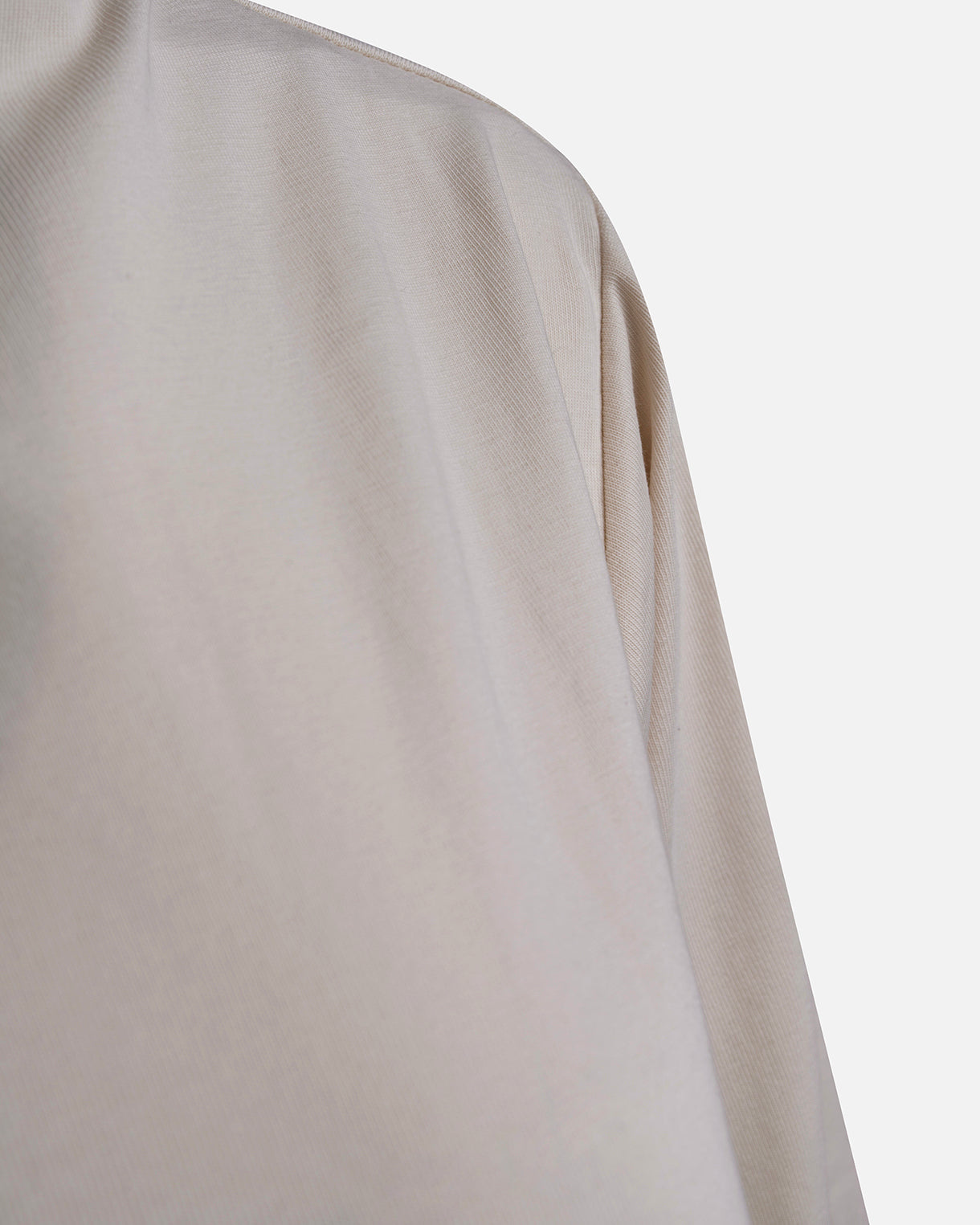 Eco-friendly abaya dress made of Sorona bio-cotton, lightweight and breathable material in color off white, close up cotton material displayed on a neutral background