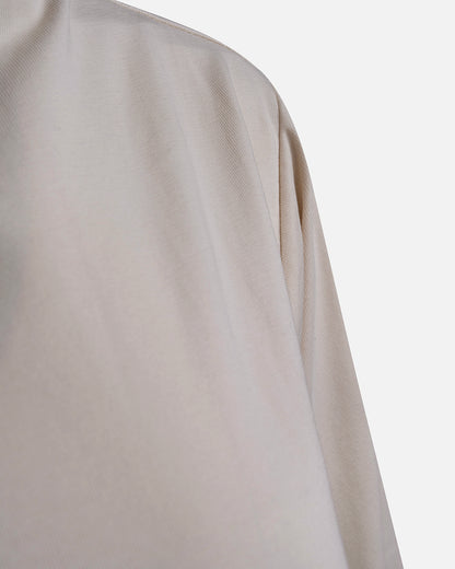 Eco-friendly abaya dress made of Sorona bio-cotton, lightweight and breathable material in color off white, close up cotton material displayed on a neutral background