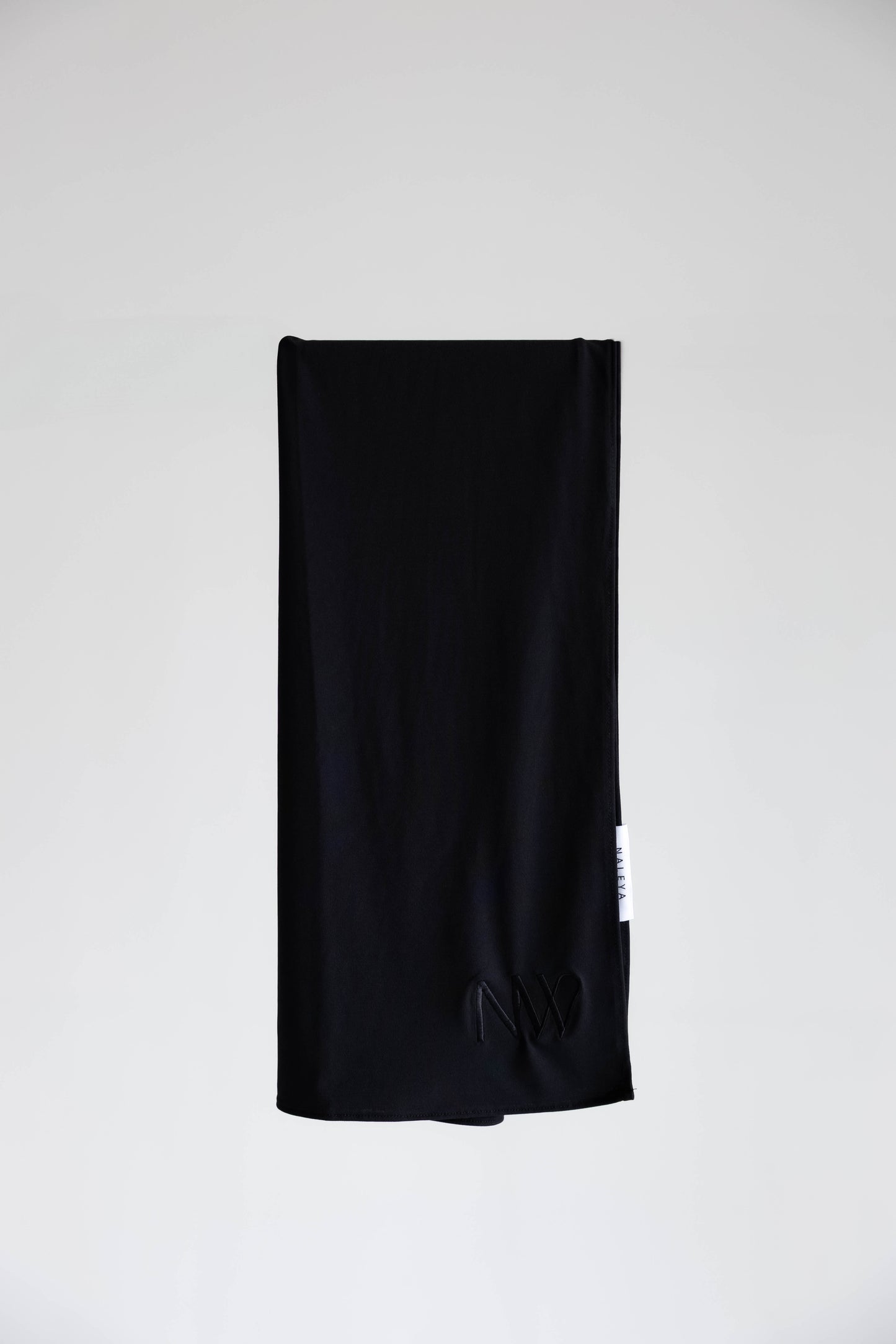 Premium jersey hijab in black by Naleya Wear, folded and displayed on a neutral background