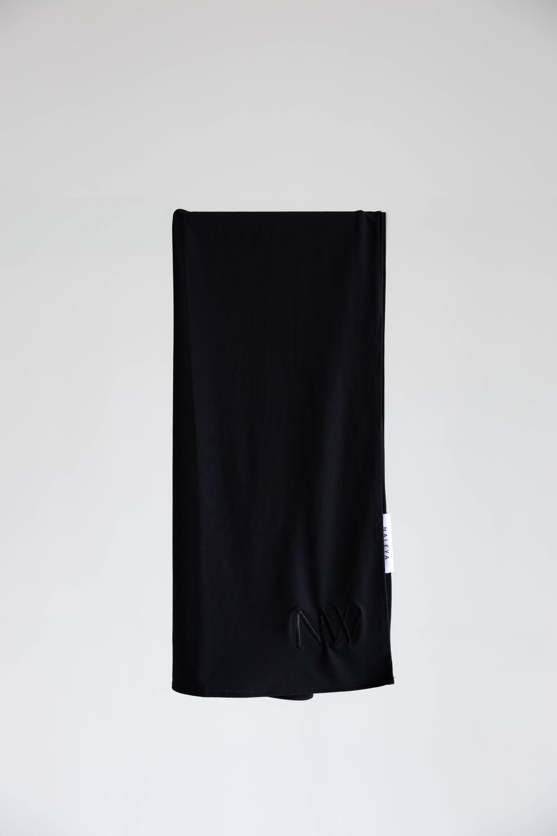 Premium jersey hijab in black by Naleya Wear, folded and displayed on a neutral background
