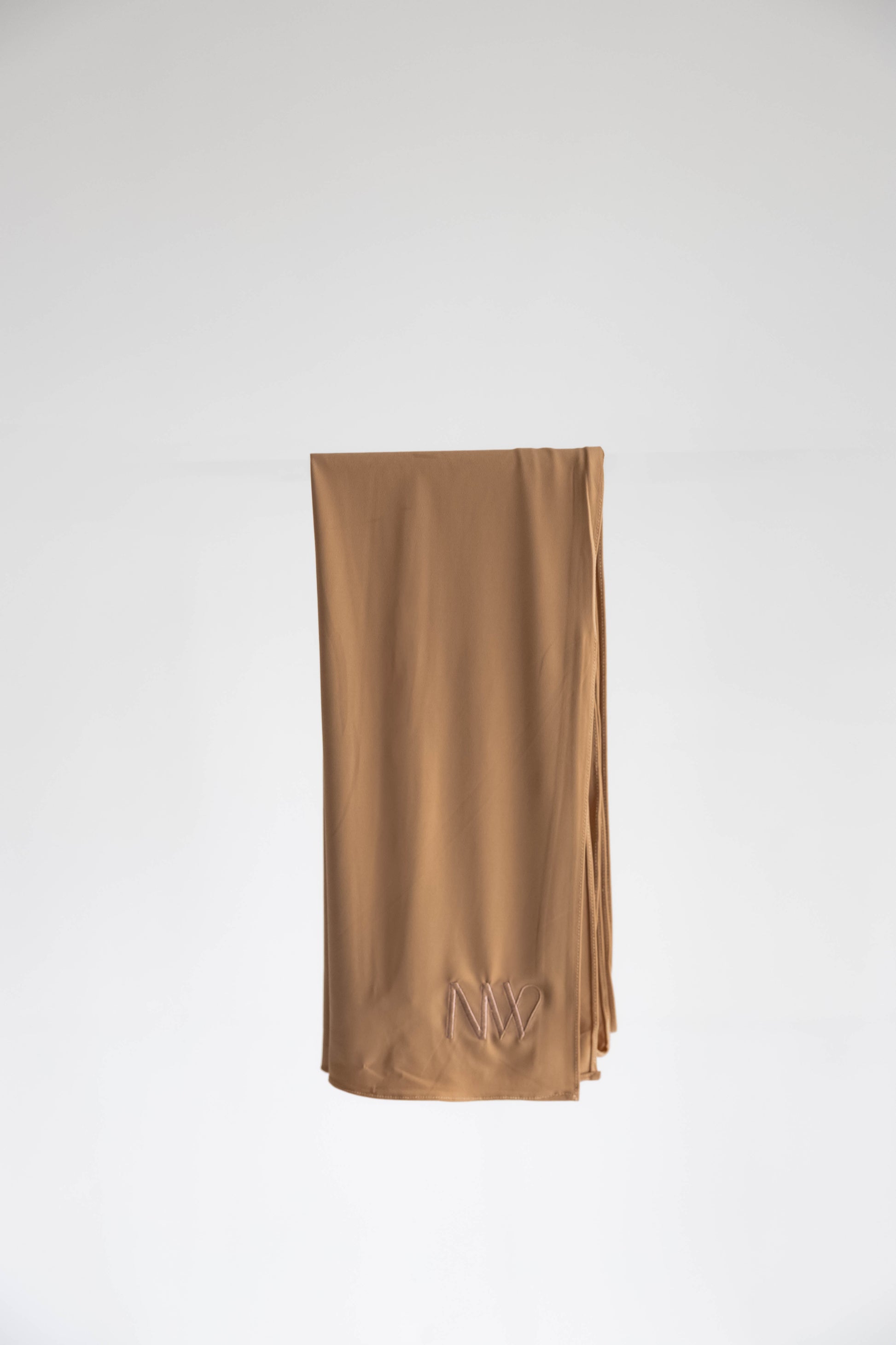 Premium jersey hijab in bronze brown by Naleya Wear, folded and displayed on a neutral background
