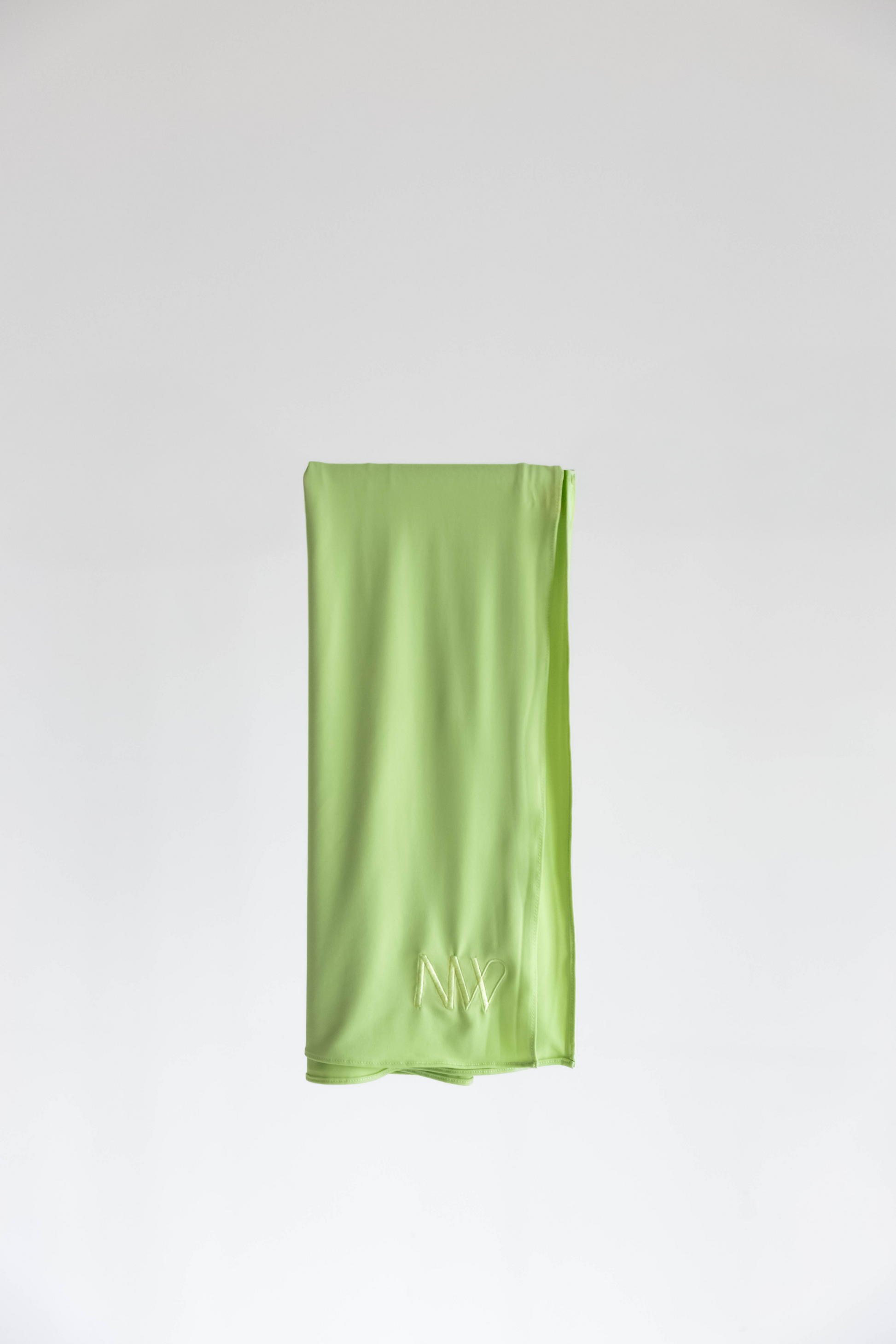 Premium jersey hijab in green by Naleya Wear, folded and displayed on a neutral background