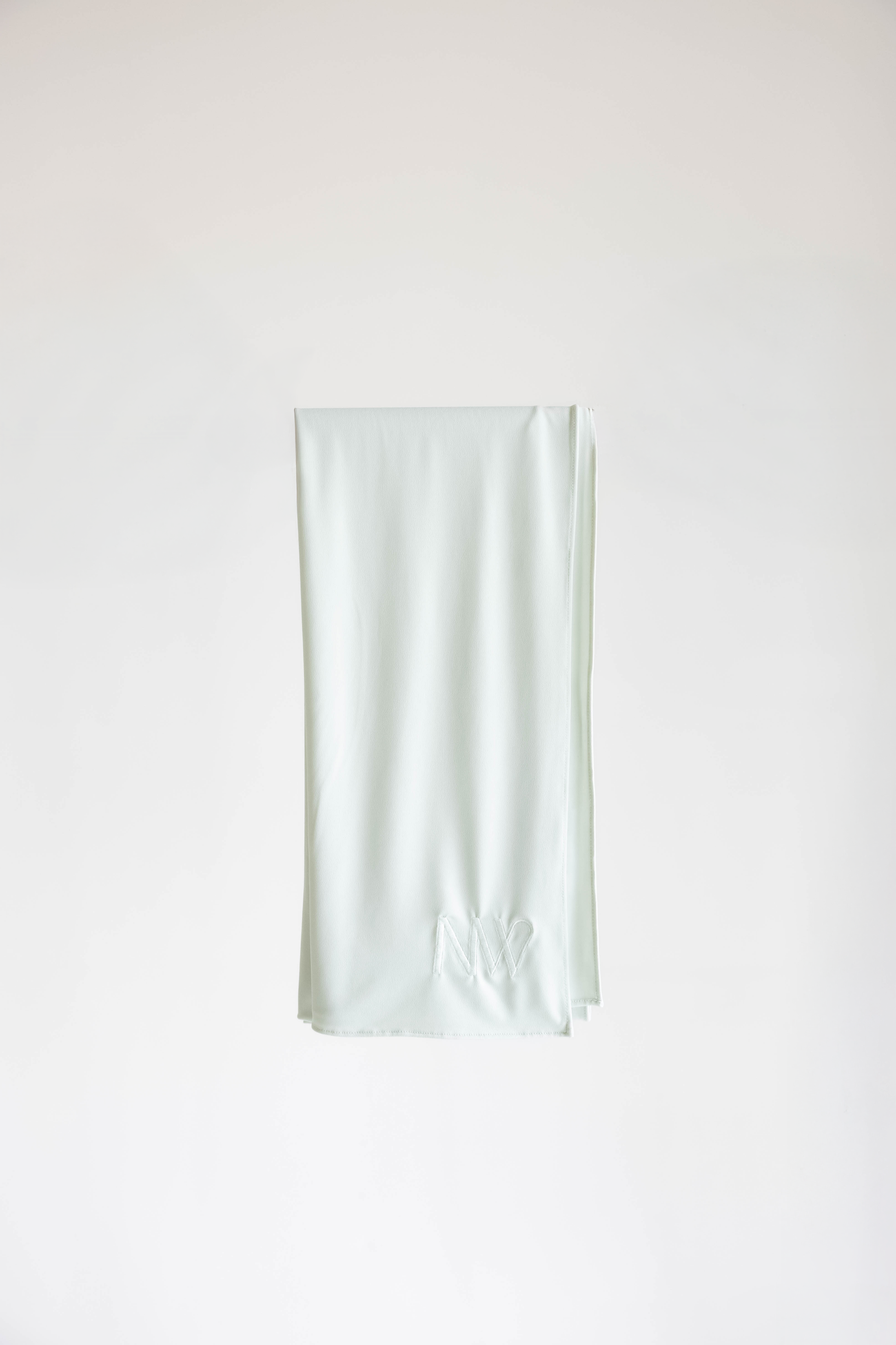 Premium jersey hijab in ice white by Naleya Wear, folded and displayed on a neutral background
