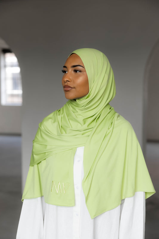 Model wearing a premium jersey hijab in green color by Naleya Wear