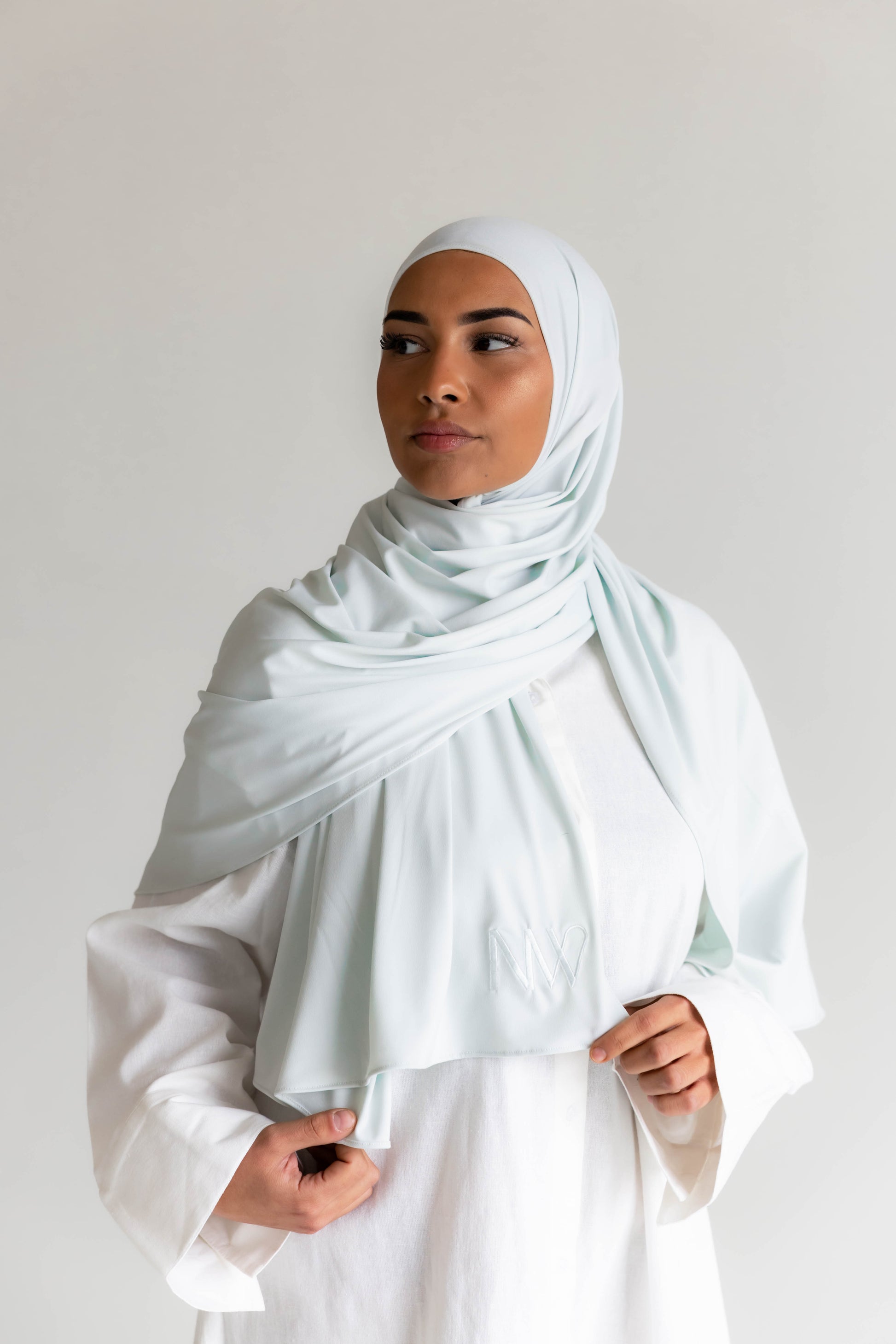Model wearing a premium jersey hijab in ice white color by Naleya Wear