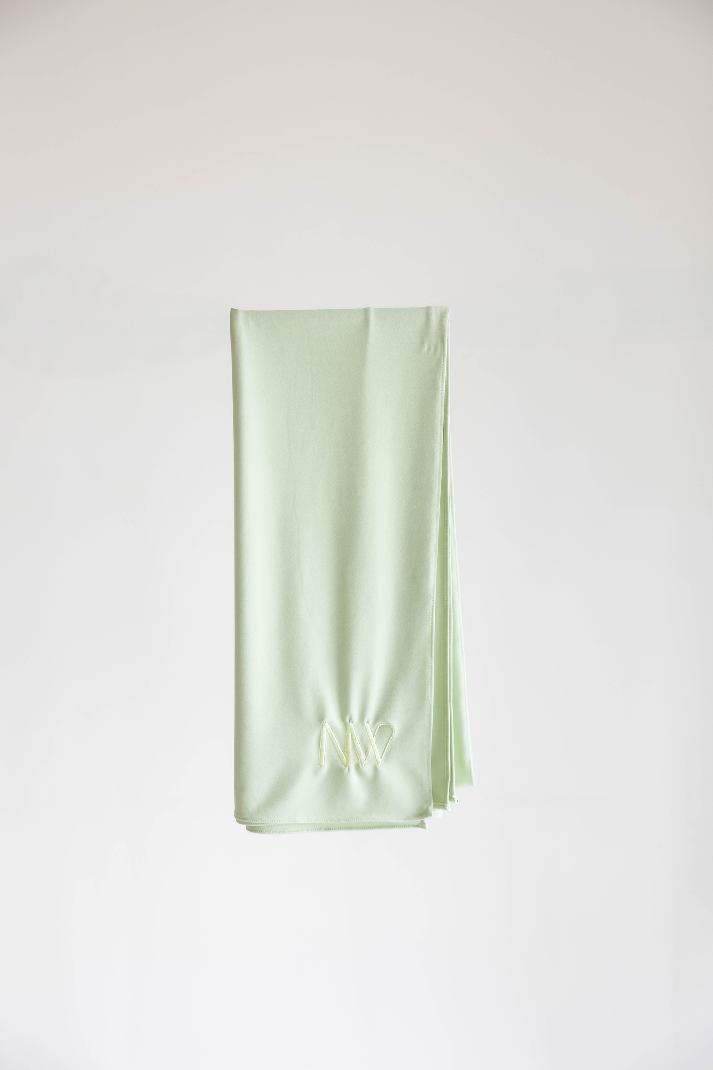 Premium jersey hijab in pastel green by Naleya Wear, folded and displayed on a neutral background